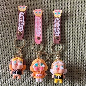 New CryBaby keychains or bag charms.